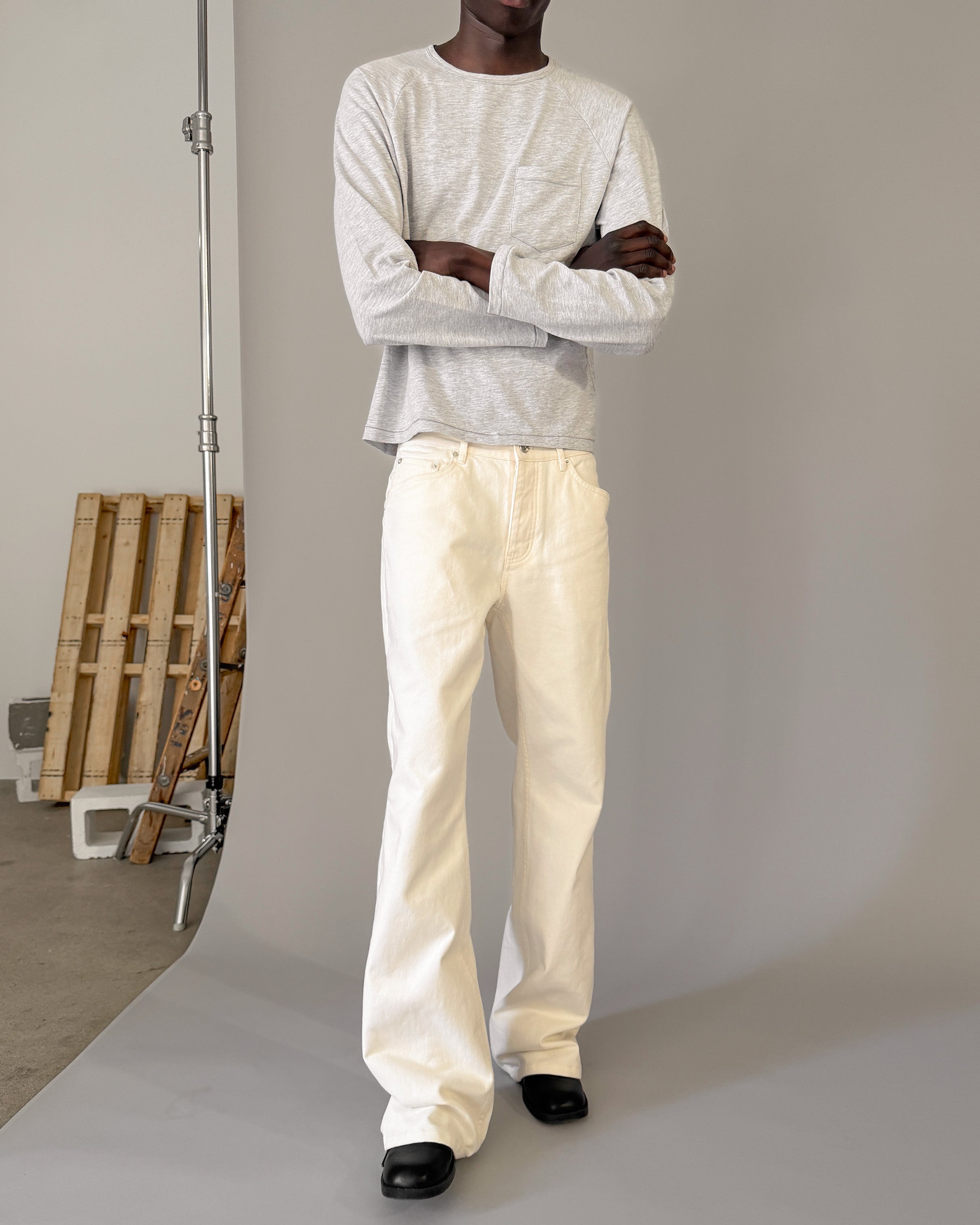 Men's ivory bootcut denim jeans in motion
